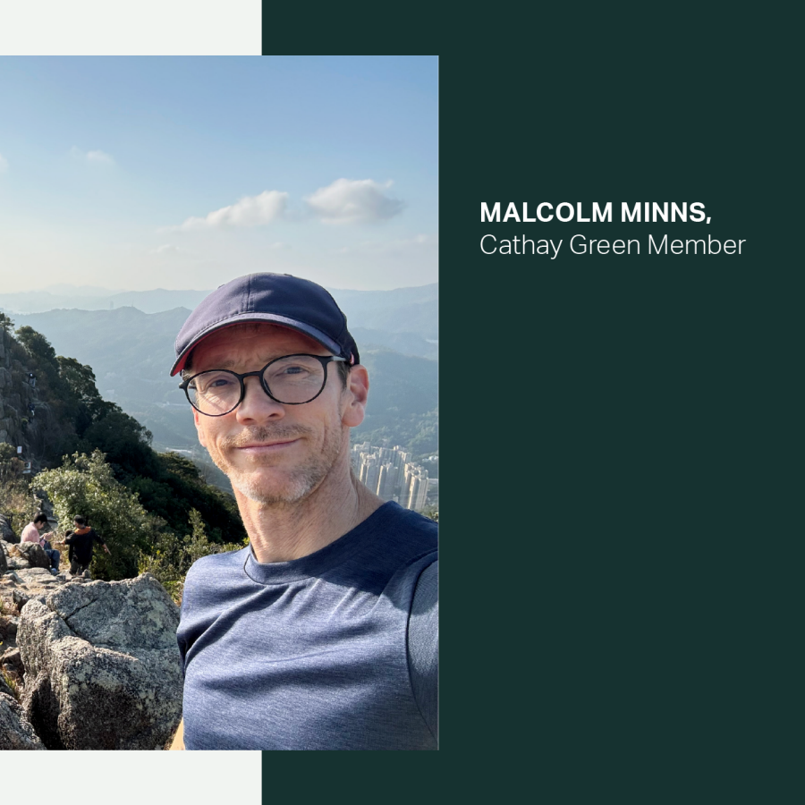 Malcolm Minns smiling on a hiking trail on a sunny day. 